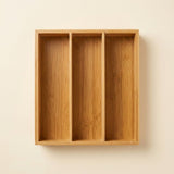 A three-compartment bamboo wall-mounted organizer box with a natural wood grain finish, shown against a plain off-white wall.