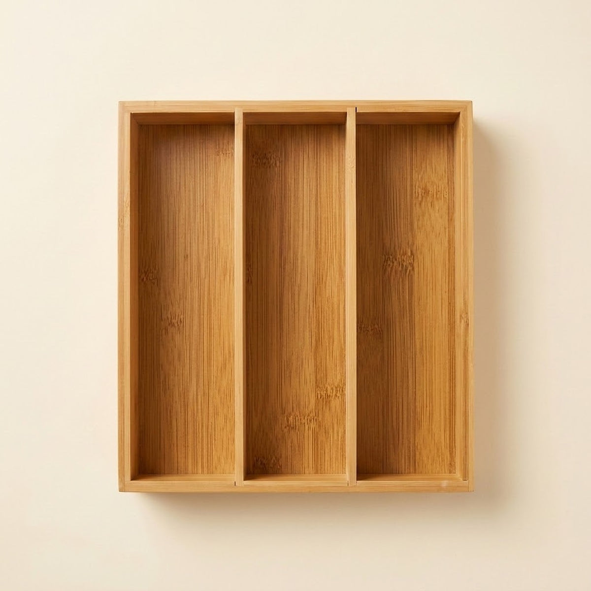 A three-compartment bamboo wall-mounted organizer box with a natural wood grain finish, shown against a plain off-white wall.