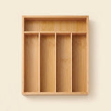 A rectangular bamboo organizer tray with four vertical compartments and a top shelf, shown against a plain beige background.
