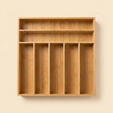 A light natural wood wall-mounted organizer with five vertical compartments and two upper shelves, shown against a plain beige wall.