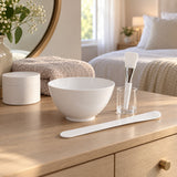 Face mask mixing bowl set arranged on a bedroom dressing table for an at-home facial routine.