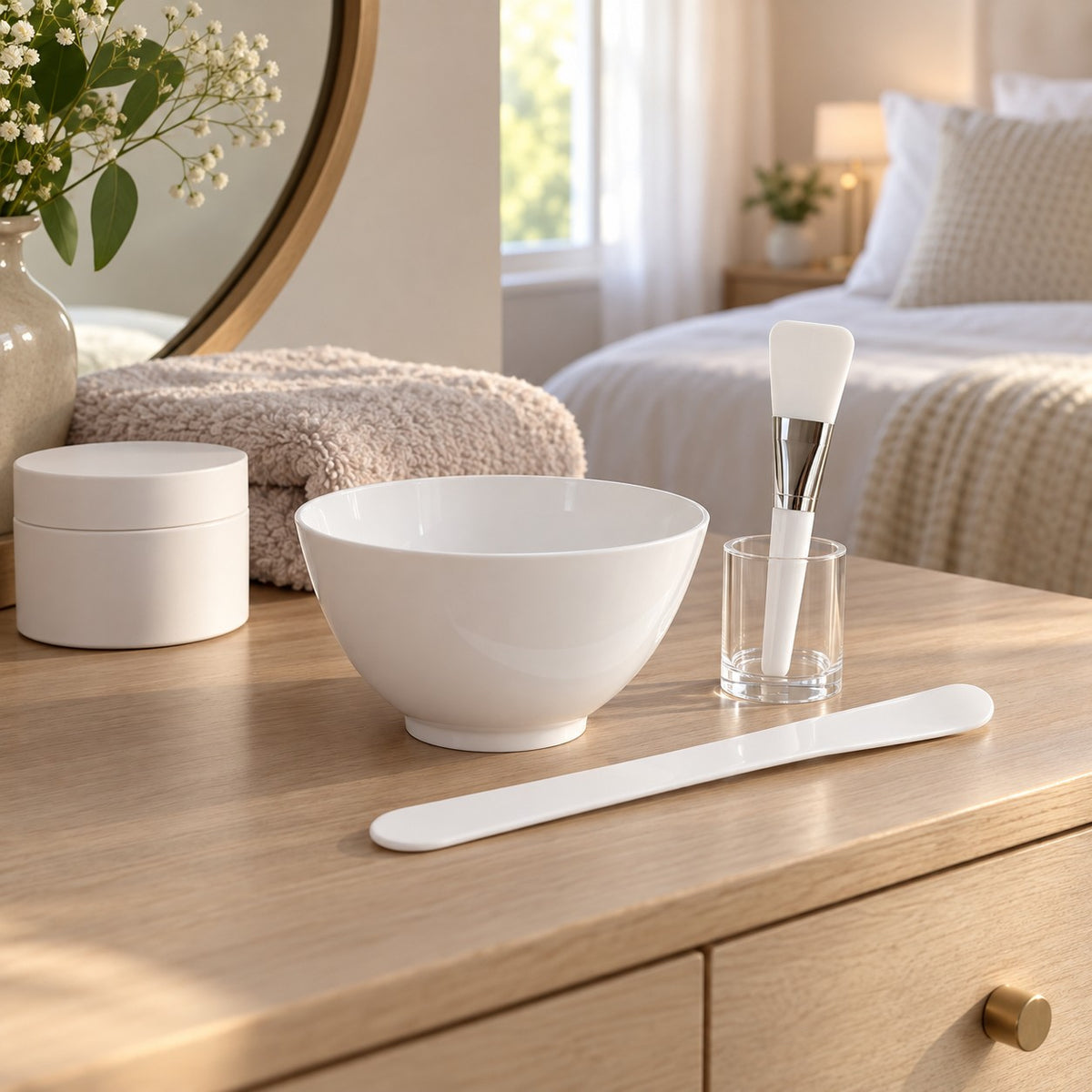 Face mask mixing bowl set arranged on a bedroom dressing table for an at-home facial routine.