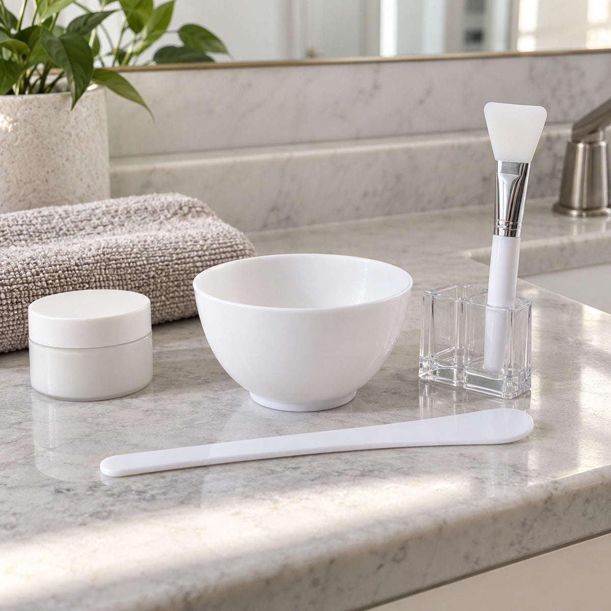 Compact face mask mixing bowl set shown beside a folded hand towel and skincare jar.