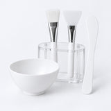 Two-applicator face mask mixing bowl set with bowl, spatula, brush, silicone tool and holder.