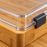 A close view of the Charcuterie Board shows bamboo grain beside its clear plastic lid.