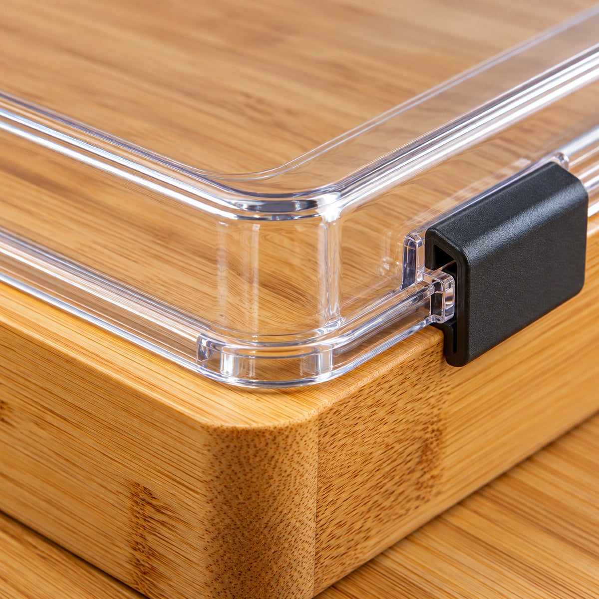 A close view of the Charcuterie Board shows bamboo grain beside its clear plastic lid.