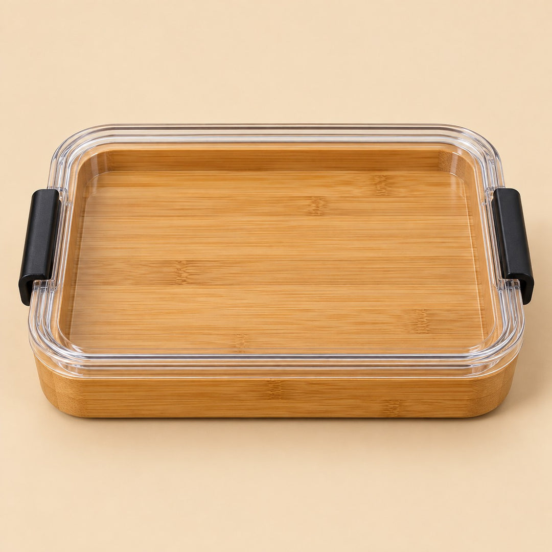 The undivided Charcuterie Board has a flat bamboo surface beneath its clear lid.