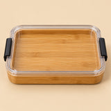 The undivided Charcuterie Board has a flat bamboo surface beneath its clear lid.