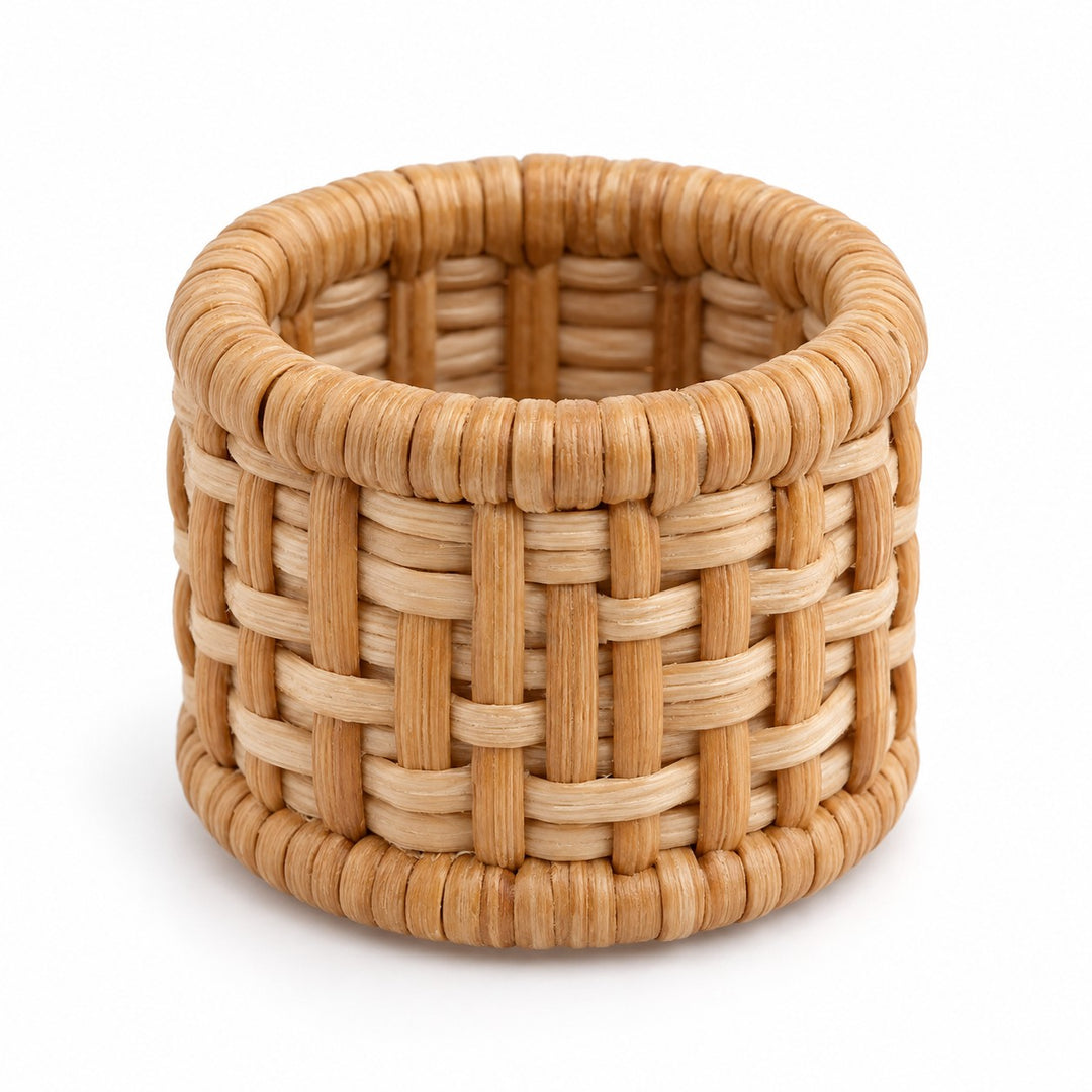 One natural tan basket-weave rattan napkin ring shown alone against a white background.