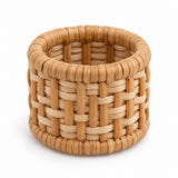One natural tan basket-weave rattan napkin ring shown alone against a white background.