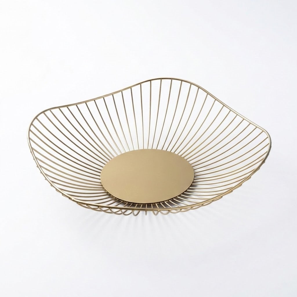 A modern wire bowl with a gold finish, featuring a slatted open design and a solid circular base, shown on a clean white background.
