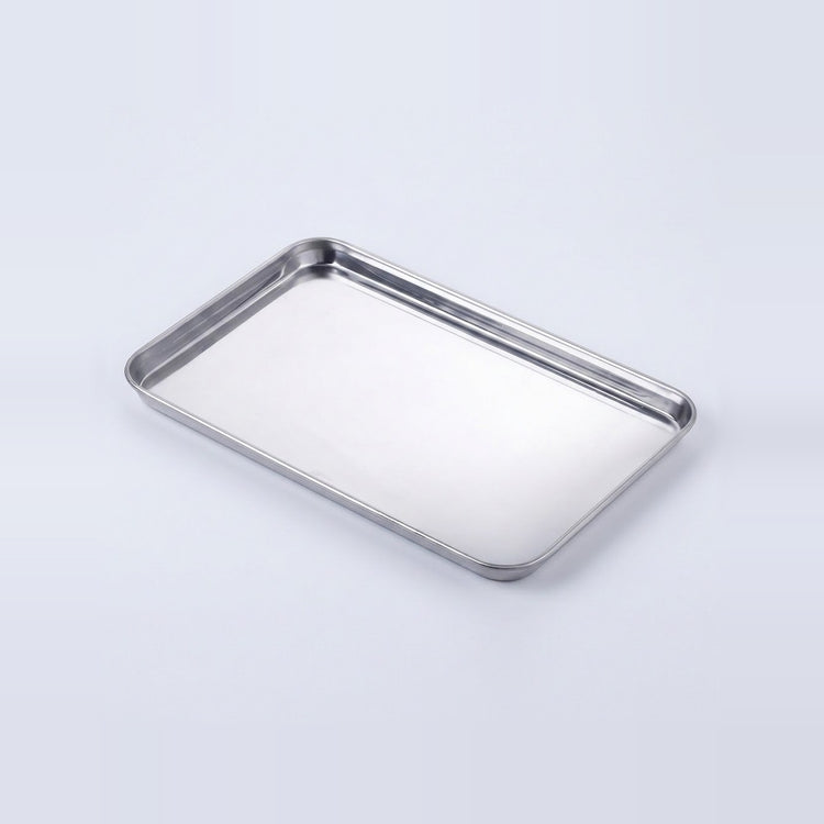 A rectangular stainless steel tray with raised edges, shown at an angle on a clean white background.
