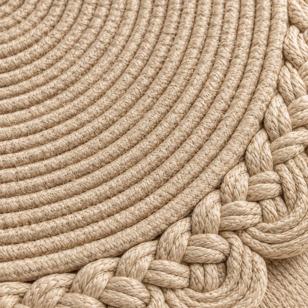 Close view of beige woven placemat cords and the braided scalloped border.