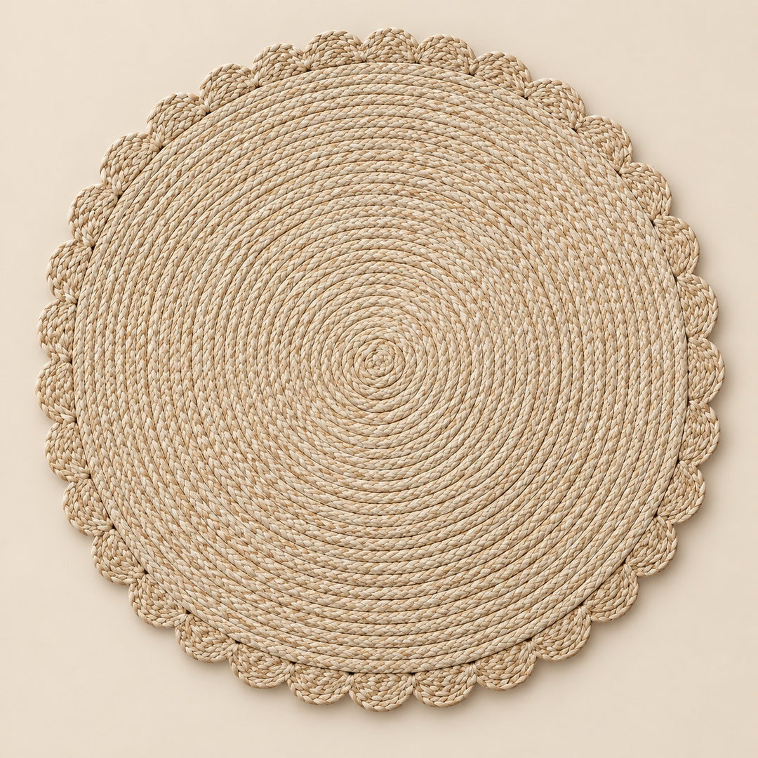 Single beige round woven placemat with braided edge on a pale beige backdrop.