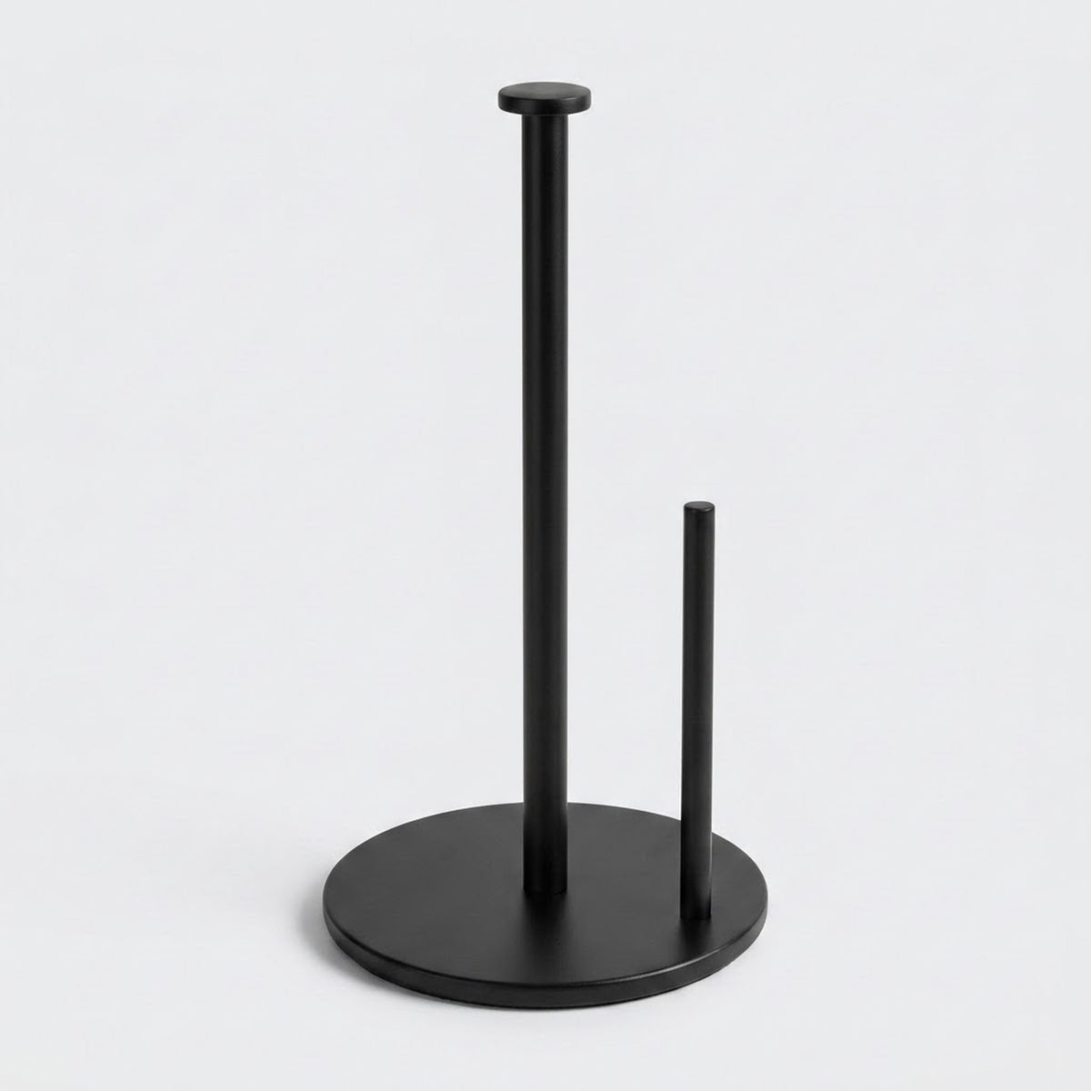 A matte black paper towel holder with two vertical stand arms and a round base, shown on a clean light gray background.