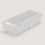 A clear plastic egg carton with a matching transparent lid, photographed on a plain light background.