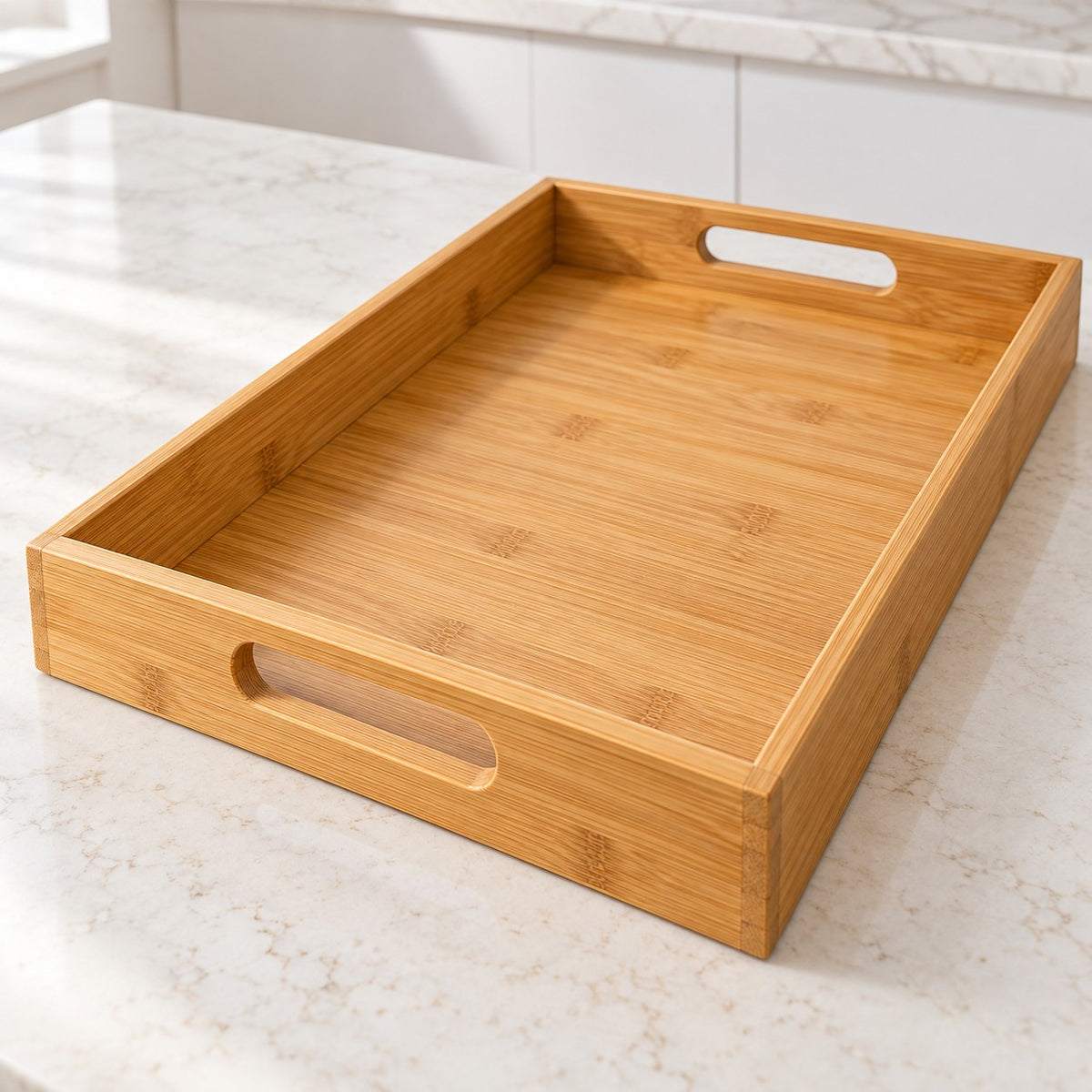 Bamboo and wood serving tray shows its built-in oval handles and raised rim on a kitchen counter.