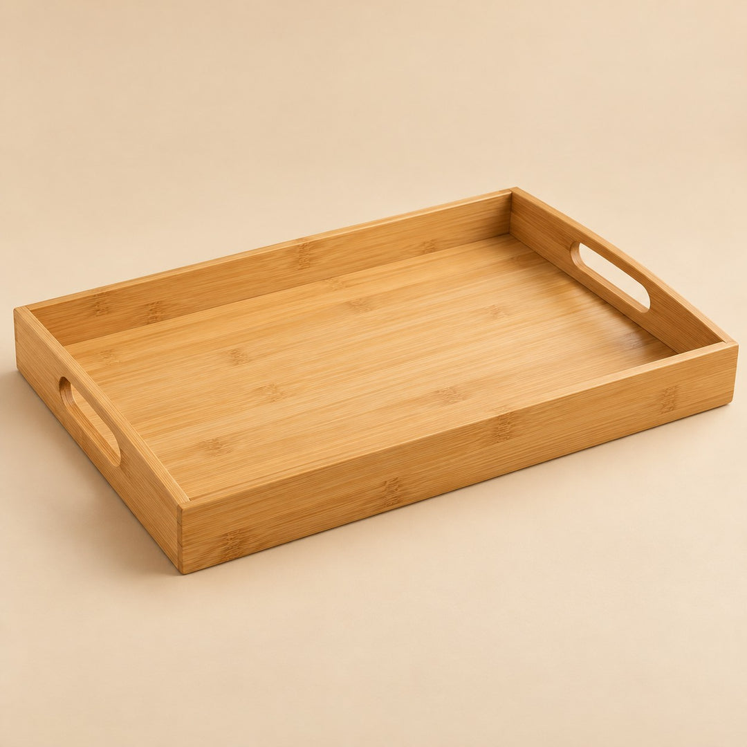 Bamboo and wood serving tray in the 45 by 33 cm size, shown alone on a warm beige studio backdrop.