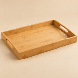 Bamboo and wood serving tray in the 45 by 33 cm size, shown alone on a warm beige studio backdrop.