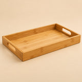 Bamboo and wood serving tray in the 30 by 20 cm size, shown alone on a warm beige studio backdrop.