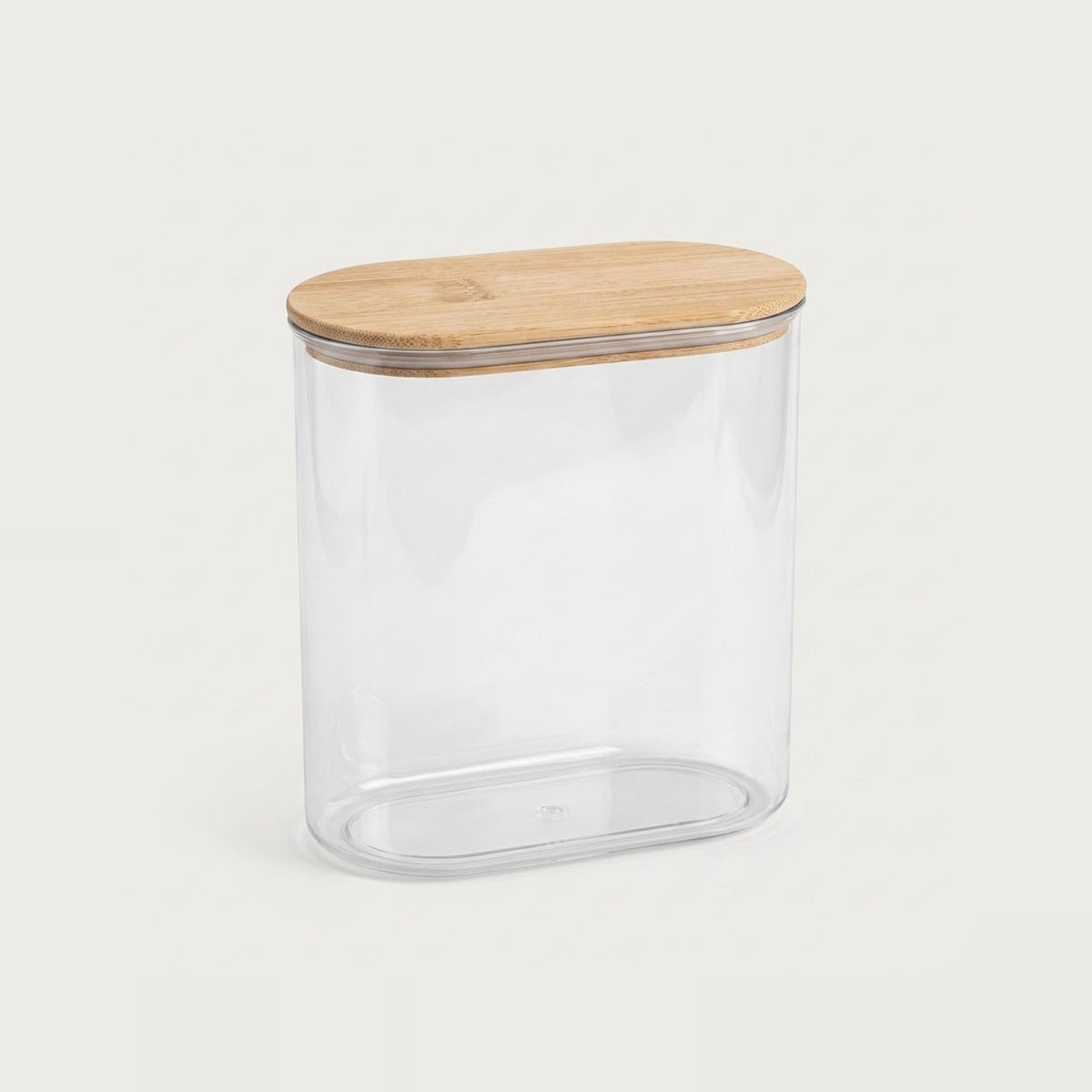 A clear cylindrical storage jar with a rounded rectangular shape and a light natural wood lid, shown on a plain light gray background.