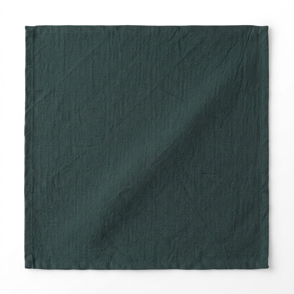 A square dark forest green fabric item, likely a napkin, pocket square, or small cloth accessory, displayed flat against a clean white background.