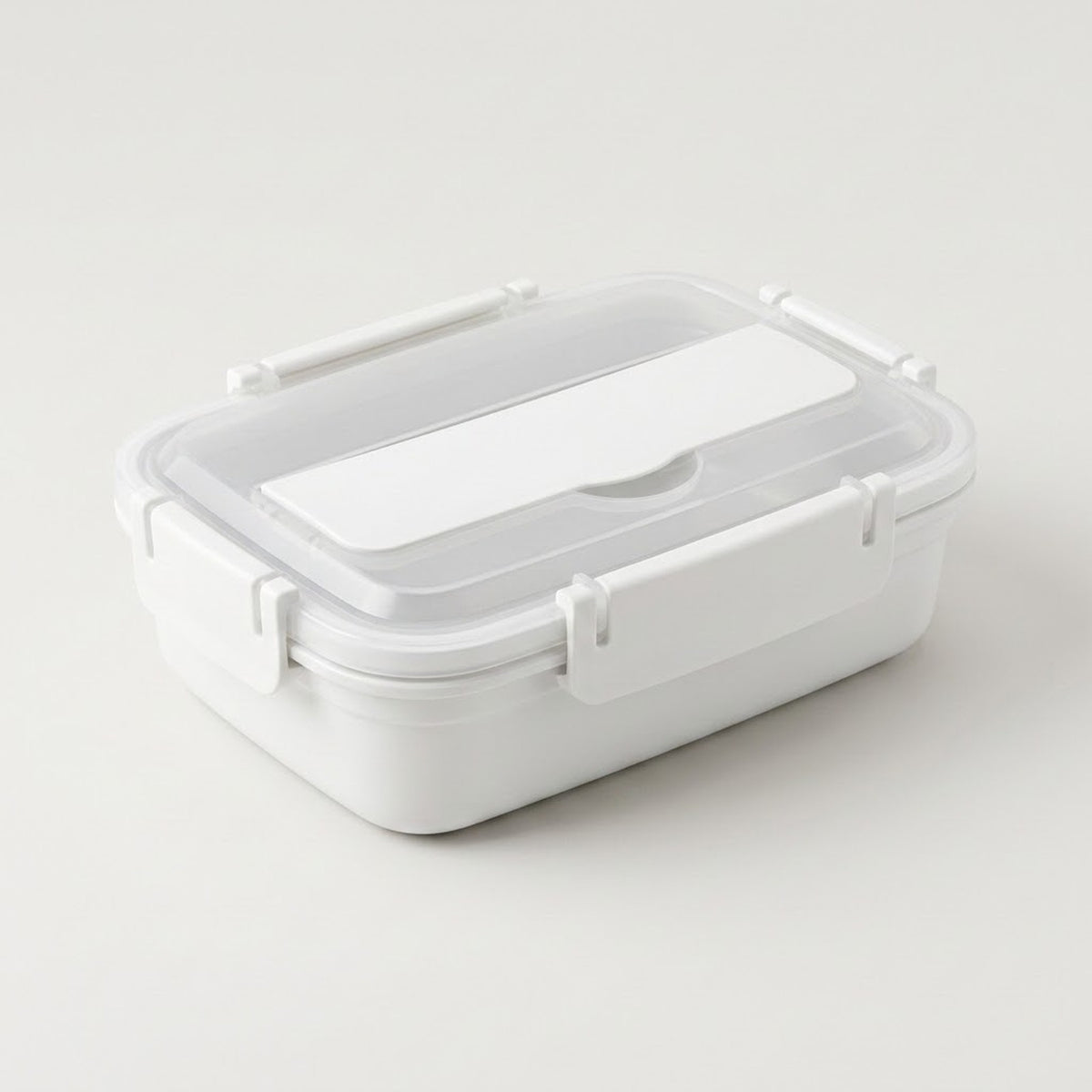 A white plastic lunch box with a clear lid and white latch closures, photographed on a clean light gray studio background.