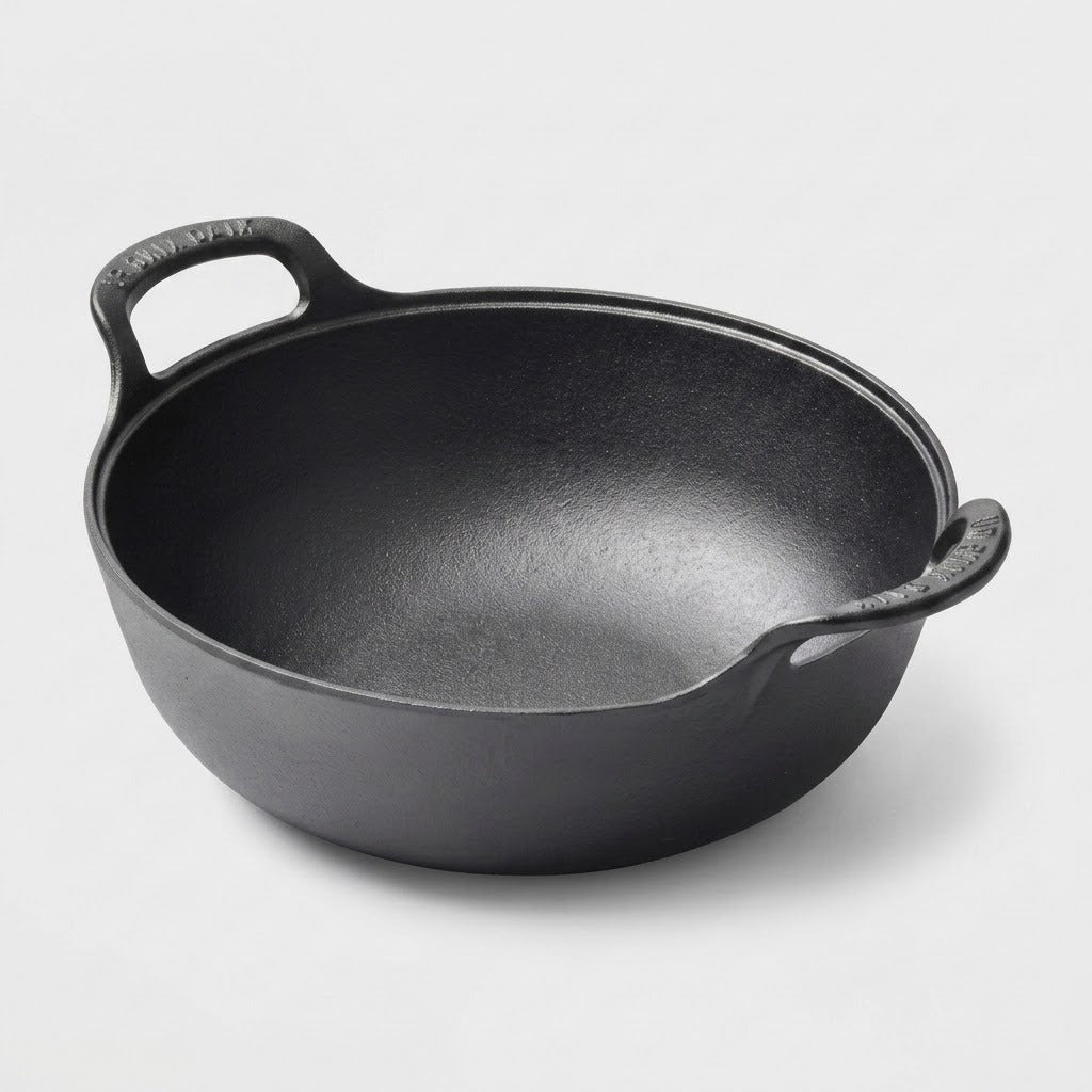 A black cast iron pot with two loop handles, photographed on a clean light gray background.