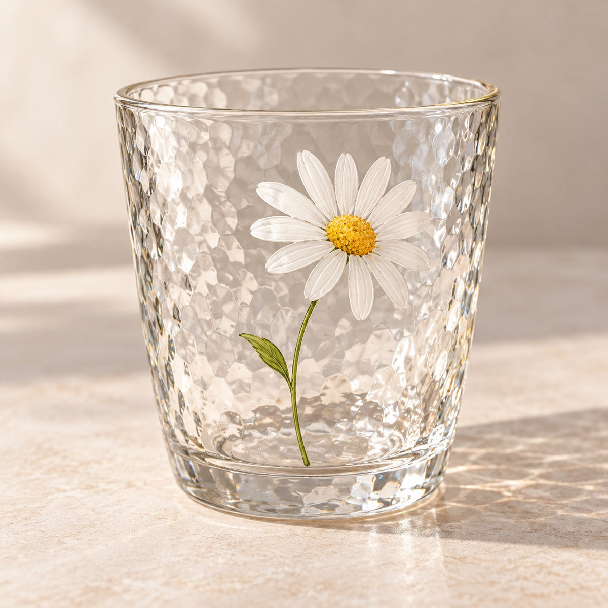 The short Hammered Daisy Glass Cup shows its daisy print and distinctive hammered glass texture.