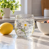 The short Hammered Daisy Glass Cup sits beside a lemon to show its everyday scale.