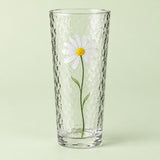 The tall Hammered Daisy Glass Cup is shown alone against a pale green studio backdrop.
