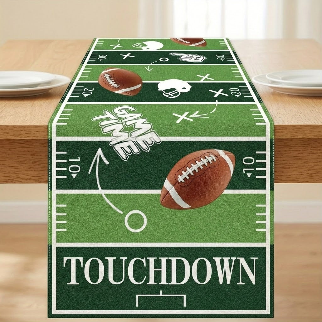 A football-themed table runner displayed on a wooden dining table. The runner features a green turf design with white yard line markings, footballs, helmets, and the words 'GAME TIME' and 'TOUCHDOWN'.