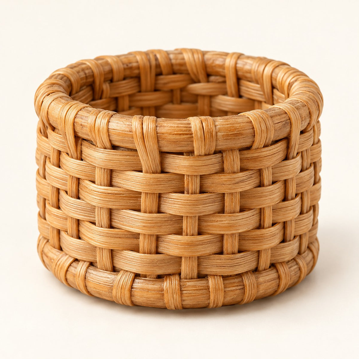 Close hero view shows the napkin ring’s sturdy, tightly woven rattan basket weave.