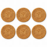 Six round rattan coasters arranged on white show the pieces included in the set.