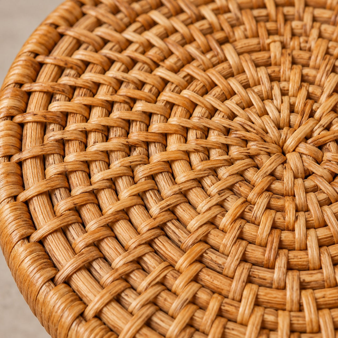 Macro view shows the warm natural fibers and tightly interlaced texture of a rattan coaster.