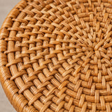 Macro view shows the warm natural fibers and tightly interlaced texture of a rattan coaster.