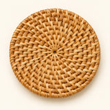 Close hero view highlights the coaster’s compact round shape and distinctive radial rattan weave.