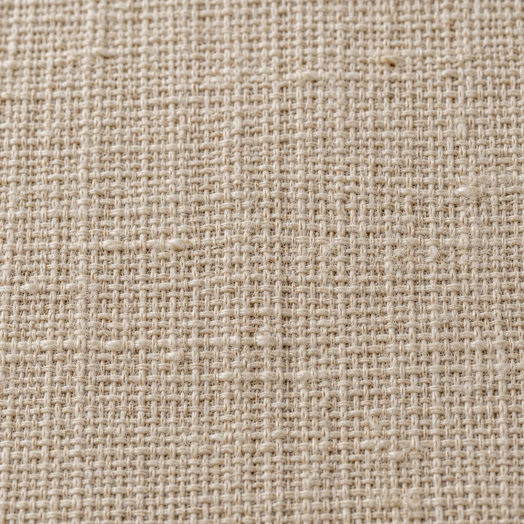 Close view of the beige table runner's fine crosshatch cotton linen weave and matte finish.