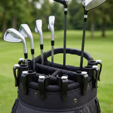 A black golf bag on a grassy golf course, holding several silver and black golf clubs.