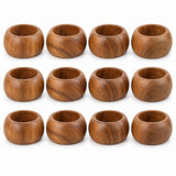 Twelve matching acacia wood napkin rings are arranged together on a clean white background.
