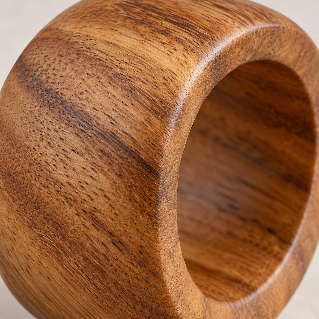 Close detail of an acacia wood napkin ring shows its fine grain and smooth polished finish.