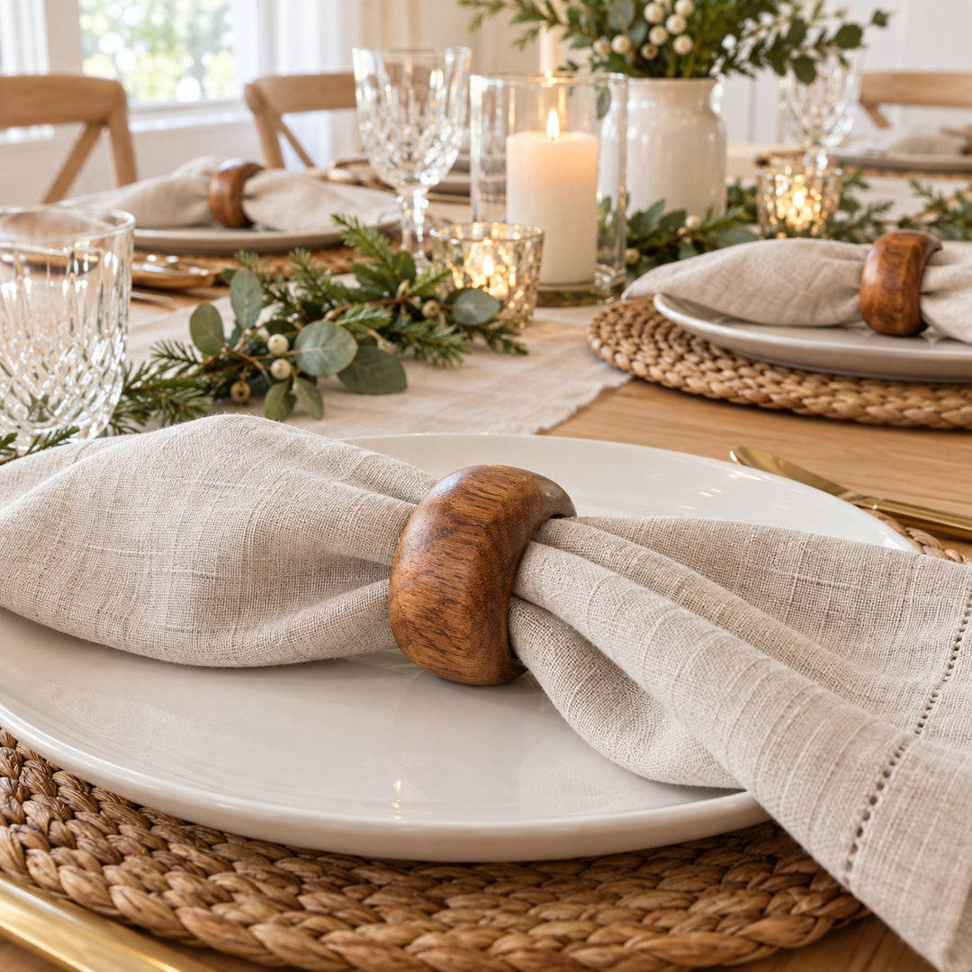 Acacia wood napkin rings hold linen napkins neatly at a softly styled holiday place setting.