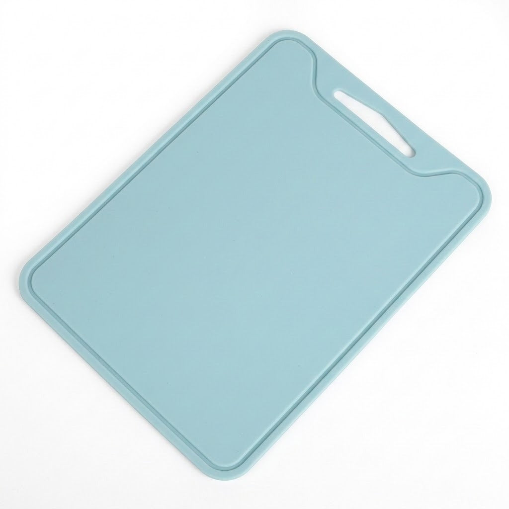 A light blue rectangular cutting board with rounded corners and a built-in handle cutout in the top right corner, shown on a plain white background.