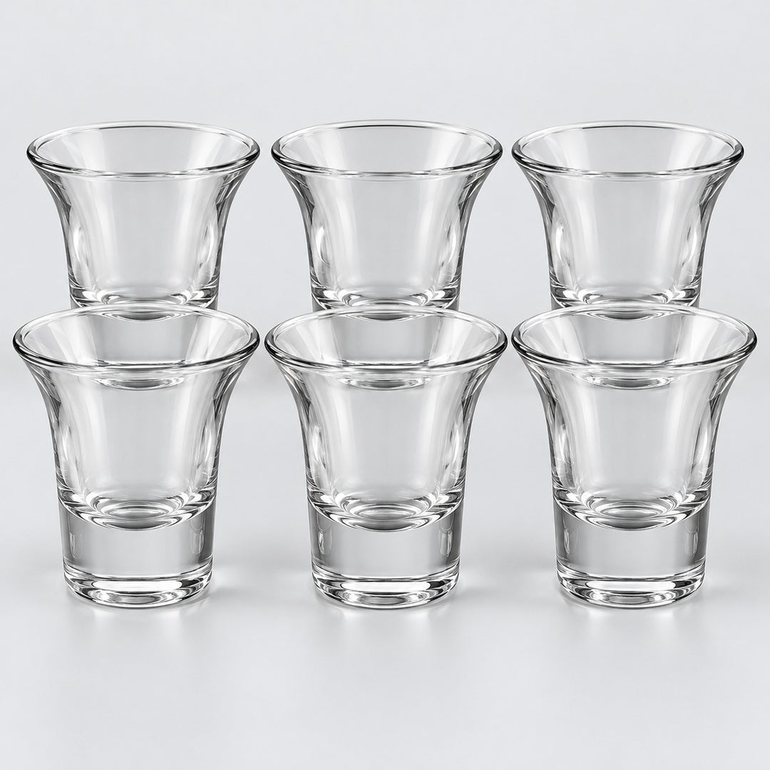 Six clear shot glasses with flared rims show the Flared Rim style on a pale backdrop.