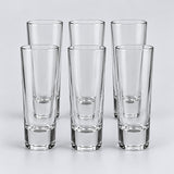 Six tall cylindrical clear glass shot glasses show the Tall Cylinder style on a pale backdrop.