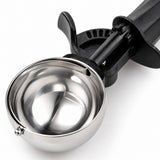 Close-up of the scoop’s reflective stainless steel bowl and textured black ABS handle.