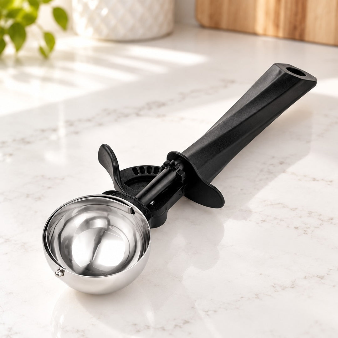 Ice cream scoop with a polished steel bowl and black trigger release mechanism.