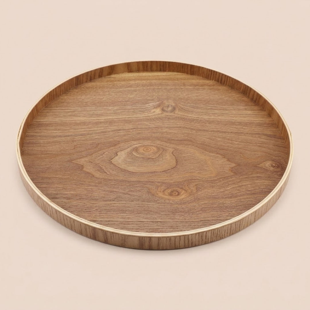A round wooden serving tray with a natural wood grain pattern and a light-colored rim, shown on a solid beige background.