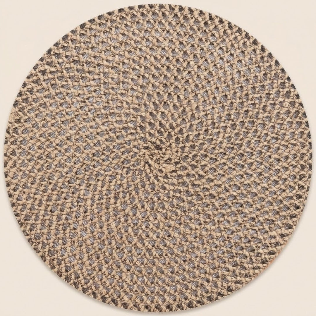 A round braided rug with a textured woven pattern in beige, brown, and gray tones, shown against a solid light beige background.