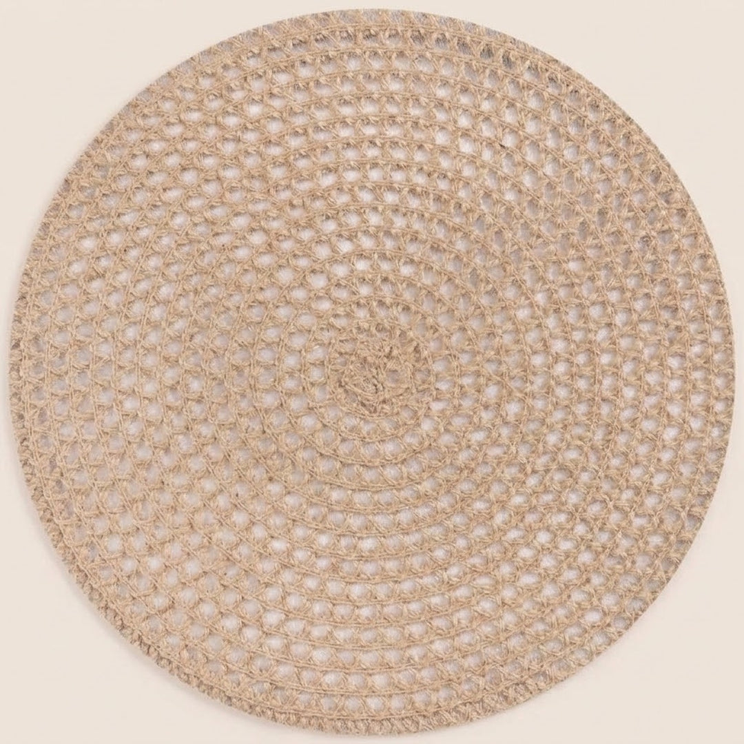 A round woven placemat or rug in a natural beige jute material, shown flat against a solid cream background.